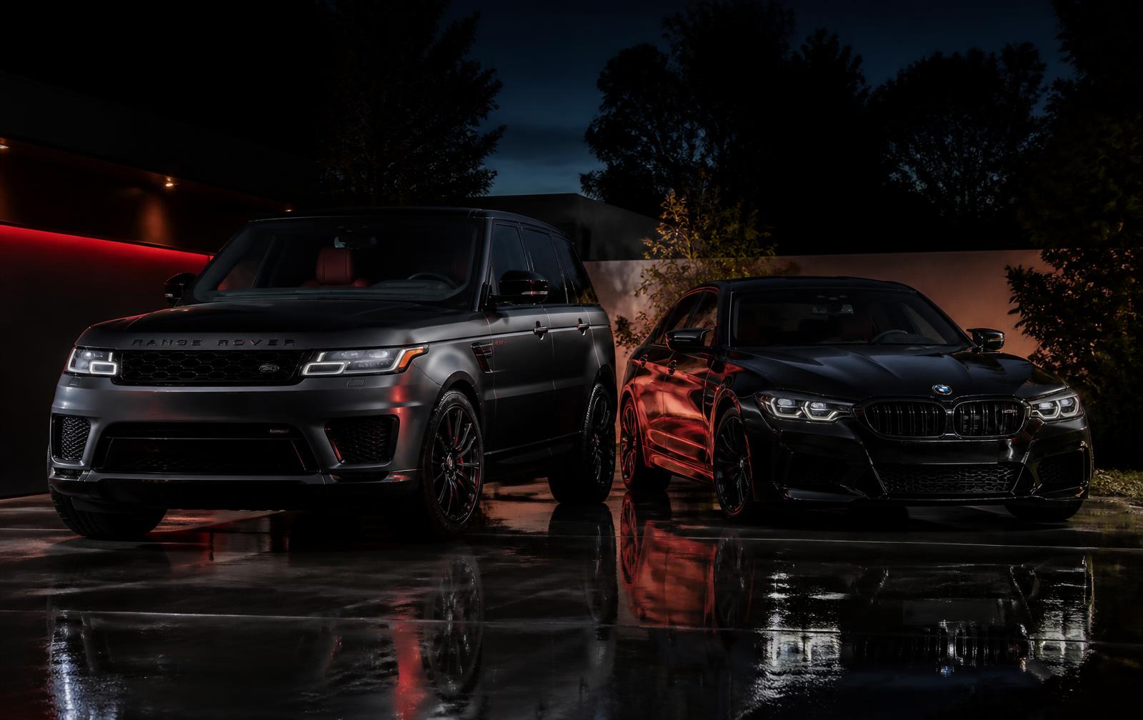 Freshly detailed luxury SUV and performance sedan on a wet driveway at dusk
